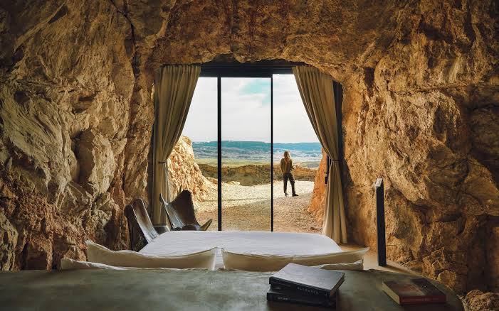 A rock-cut interior with plain walls and a single window, lit by daylight